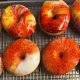 multicolor red and orange vanilla icing doughnuts with sprinkles